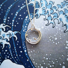 Load image into Gallery viewer, Handmade silver ocean wave necklace, on top of blue and white The Great Wave Japanese Hokusai print
